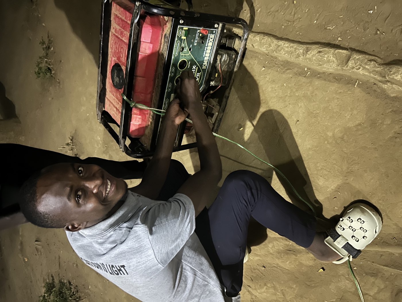 A teacher starts the generator before a lesson