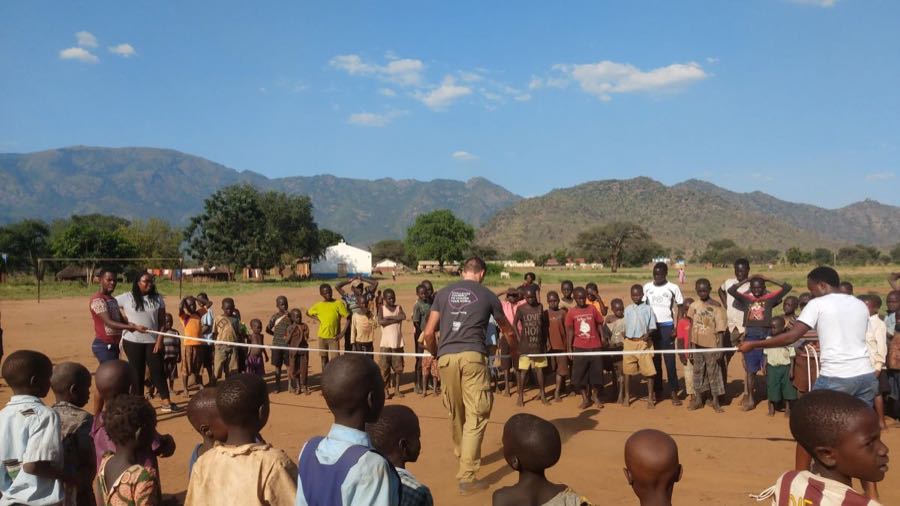 Volunteers play game with local children in North Uganda