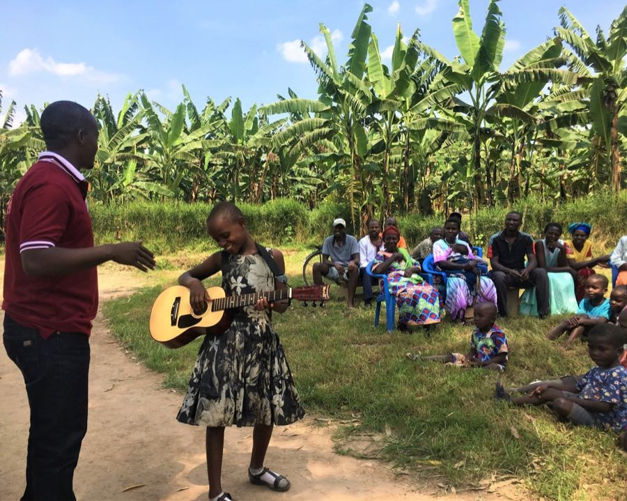 Volunteer teaches guitar