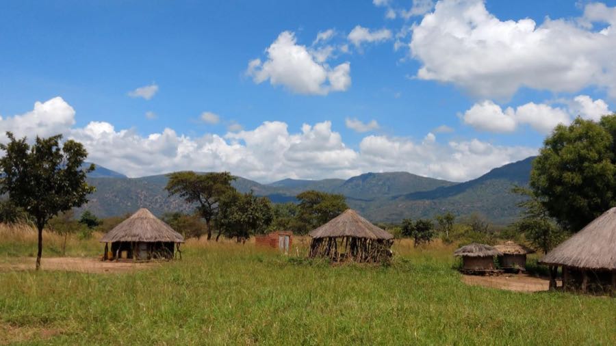 Landscape of North Uganda, huts, hills, green 