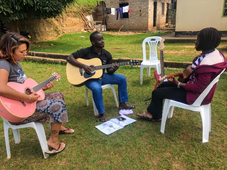 group of friends learn guitar